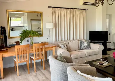 a living room with a couch and a table at Dream Views in Somerset West