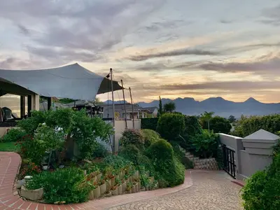 a house with a garden with a view of the mountains at Dream Views in Somerset West