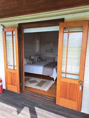 a bedroom with a bed inside of a house at Glengarry in Grabouw