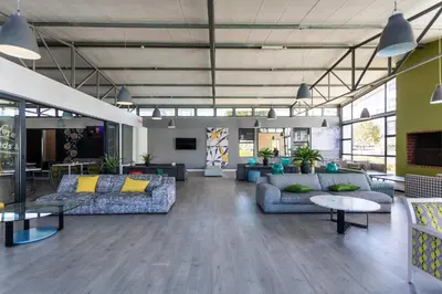 a lobby with couches and tables in a building at The Sandown 178 by CTHA in Cape Town
