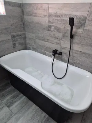 a bath tub in a bathroom with a shower at Remmy Place in Hawston