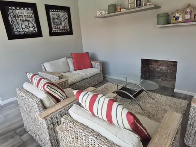 a living room with two couches and a fireplace at Remmy Place in Hawston