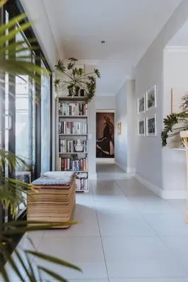 a living room with a book shelf filled with books at Between the Ocean and Winelands in Croydon