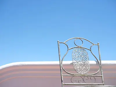 a metal chair in front of a window at Adara Palmiet Valley Luxurious Boutique Farm Hotel in Paarl