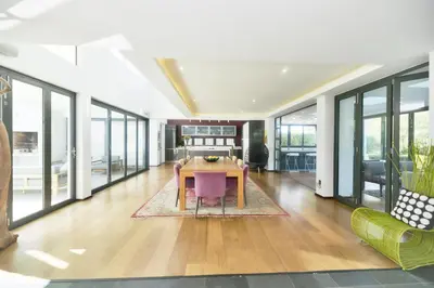 a large living room with a table and chairs at On Golf Estate Sea & Mountain Views Design Winner in Hermanus