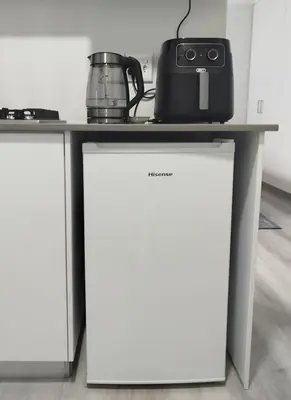 a table with a tea kettle on top of it at Hermanus C-Escape Apartment in Hermanus