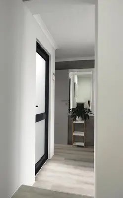 a hallway of a house with white walls and a mirror at Hermanus C-Escape Apartment in Hermanus