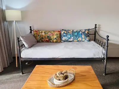 a living room with a couch and a coffee table at Franschhoek Farm Cottages in Franschhoek
