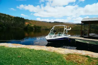 a boat is docked at a dock in the water at Elgin River Lodge in Elgin