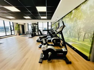 a gym with a treadmill and a wall of windows at Cape Town Studio for business travel in Cape Town