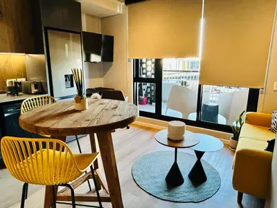 a kitchen and living room with a table and chairs at Cape Town Studio for business travel in Cape Town