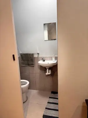 a bathroom with a sink and a toilet at HavenTrust Guest house in Goodwood