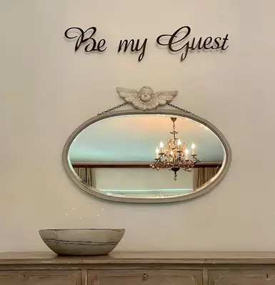 a mirror with the words be my guest on a wall at Garden Hideaway in Stellenbosch
