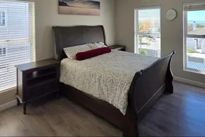 a bedroom with a large bed with a red pillow on it at 53 hillcrest in Oakdale