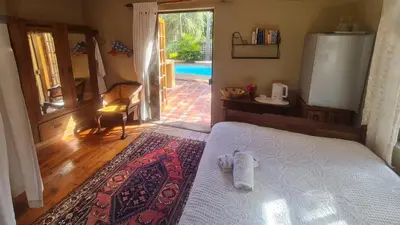 a bedroom with a bed with a towel on it at Sunbird room in Cape Town