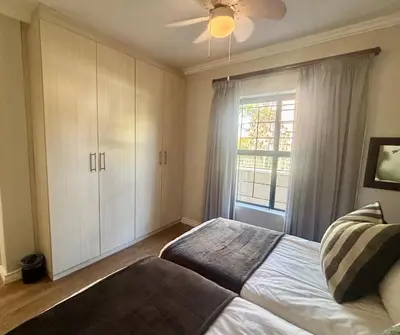a bedroom with a bed and a window at 3 Vilaroux in Stellenbosch