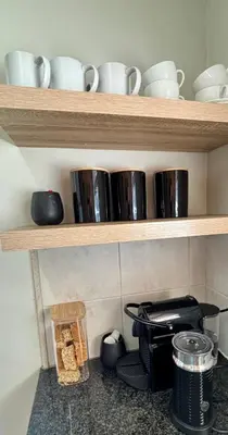 a shelf with pots and pans and dishes on it at 3 Vilaroux in Stellenbosch