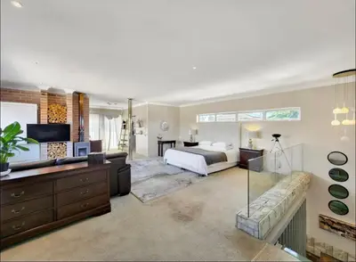 a bedroom with a bed and a living room at Sunset Bliss Villa, Sunset Beach, Cape Town in Cape Town