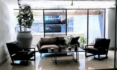 a living room with a couch and two chairs and a table at VIXIRITE APARTMENTS & HOTELs in Cape Town
