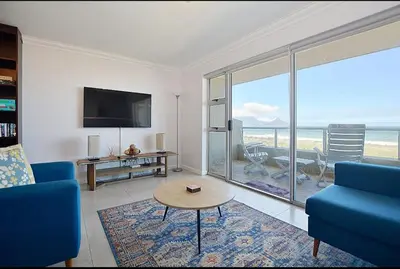 a living room with a view of the ocean at VIXIRITE APARTMENTS & HOTELs in Cape Town