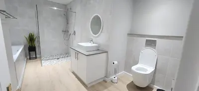 a bathroom with a toilet and a sink and a mirror at Sea 'n Summit Suite in Hermanus