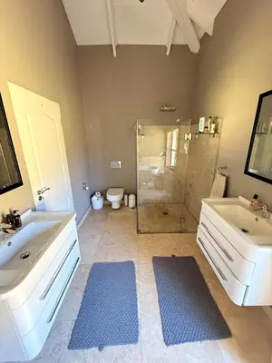 a bathroom with a shower and a sink and a tub at Charming Country Escape with Mountain Views in Hermanus