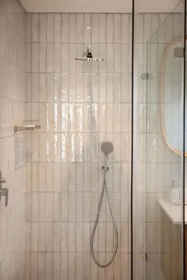 a shower with a glass door in a bathroom at One on Main in Franschhoek