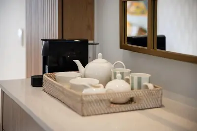 a tray with dishes and a tea set on a counter at One on Main in Franschhoek