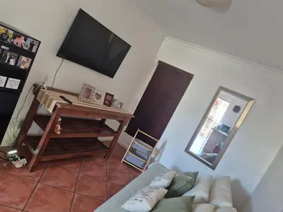 a living room with a couch and a flat screen tv at Remmys Flat in Goodwood