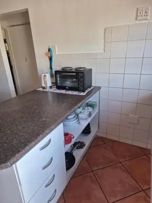 a kitchen with a counter top with a microwave at Remmys Flat in Goodwood