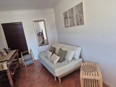 a living room with a couch and a table at Remmys Flat in Goodwood
