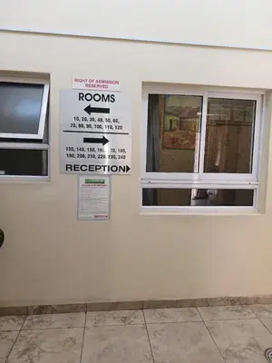 a white wall with a window and a sign on it at Lookout Star Legend Accommodation in Parow