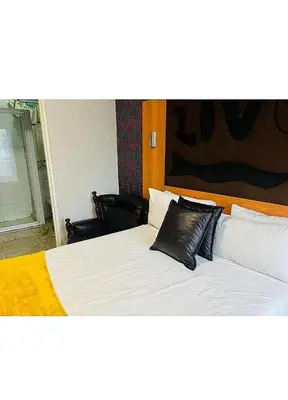a bed with a black pillow on top of it at Lookout Star Legend Accommodation in Parow