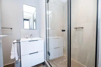 a bathroom with a shower and a sink at 715 Riverlands - Lux 2 Bedroom Apartment in Cape Town
