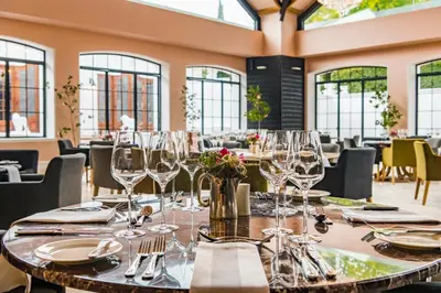 a dining room with a table with wine glasses at Lanzerac Hotel & Spa in Stellenbosch