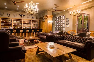 a bar with couches and tables in a room at Lanzerac Hotel & Spa in Stellenbosch