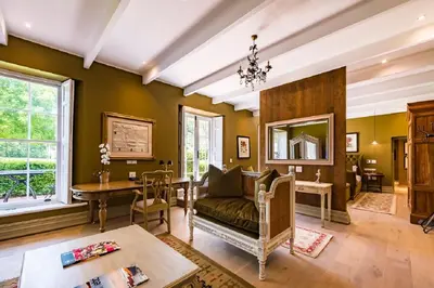 a living room with a couch and a table at Lanzerac Hotel & Spa in Stellenbosch