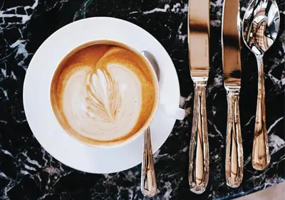 a cup of coffee with a heart painted on it at Lanzerac Hotel & Spa in Stellenbosch