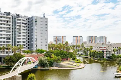 a bridge over a river in a city with buildings at Belina - Waters Edge Premier in Cape Town
