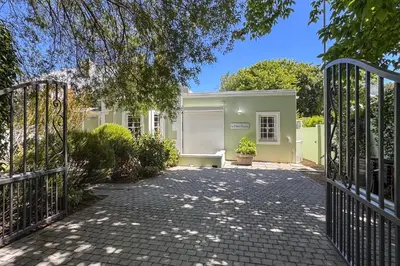 a gate to a house with a driveway at La Petite Maison in Franschhoek