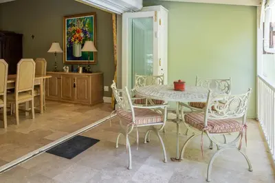 a dining room with a table and chairs at La Petite Maison in Franschhoek