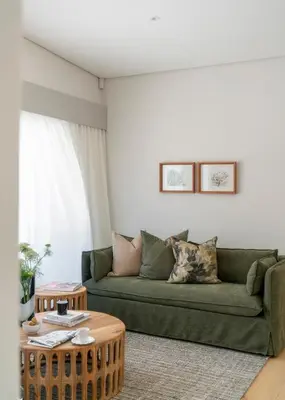 a living room with a green couch and a table at 6 on Heide in Franschhoek
