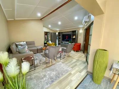 a living room with a couch and a table at Modern Van Riebeeck Park Accomodation in Worcester