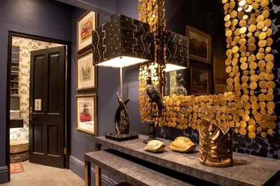 a dining room with a table with a chandelier and a table sidx sidx at La Fontaine Boutique Hotel by The Oyster Collection in Franschhoek