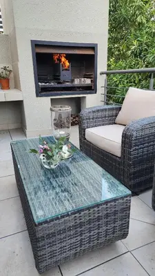 a patio with a table and a fire place at Water side Town house on the canal in Cape Town