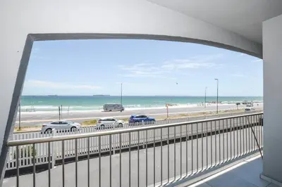 a view of a highway with a view of the beach at Ocean View Apartment in Blouberg Beachfront in Cape Town