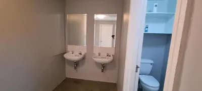 a bathroom with two sinks and a toilet at Studio Kiters Room - Dolphin Beach in Cape Town