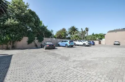 a group of cars parked in a parking lot at Modern 1 Bedroom Apartment in Blouberg in Cape Town