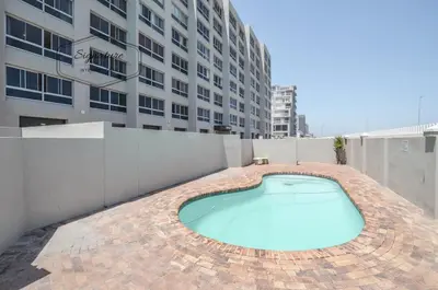 a swimming pool on top of a building at 2 Bedroom Apartment - Zeezicht Blouberg in Cape Town