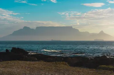 a view of the table mountain from the beach at 2 Bedroom Apartment - Zeezicht Blouberg in Cape Town